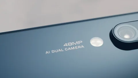 Macro shooting of the camera module of the smartphone on the back Stock Footage 113328344