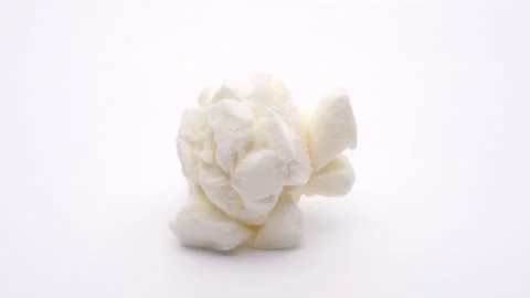 Macro shooting of one popcorn. Rotating on white background. Stock Footage 157083721