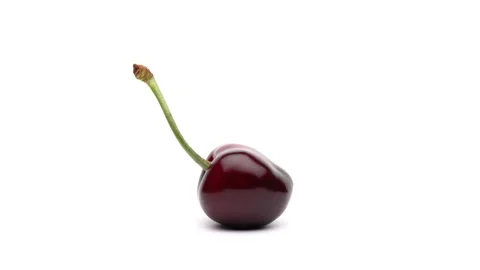 Macro shooting of one sweet cherry is rotating on the turntable. Isolated on Stock Footage 157051532