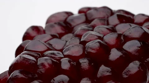 Macro shooting of opened pomegranate fruit slowly rotating. Isolated on white Stock Footage 170267237