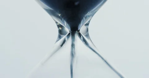 Macro shooting of the sand clock where sand running down on the white background 動画素材 86464775