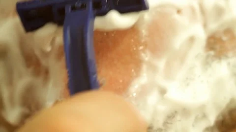 Macro shooting of shaving bristles from the face of a man with a shaving machine Stock Footage 82354822