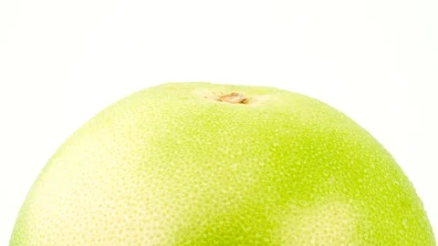 Macro shooting of upper part of green oroblanco fruit with water drops. Stock Footage 98181249