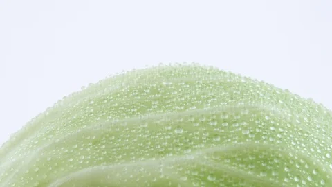 Macro shooting of upper part of white cabbage leaves with water drops. 스톡 동영상 93844646