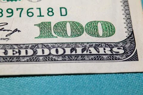 Macro shot of the 100 and RED DOLLARS text on a US one hundred dollar billM.. Stock Photos