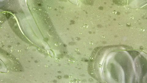 Macro Shot of air Bubbles in Transparent Cosmetic Liquid Gel Cream. Green Video stock 155069321