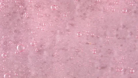 Macro Shot of air Bubbles in Transparent Cosmetic Liquid Gel Cream. Red Fluid Stock Footage 157887258