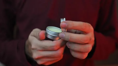 Macro Shot of Aluminum Balm Container Held in Human Hands Stock Footage 337847518