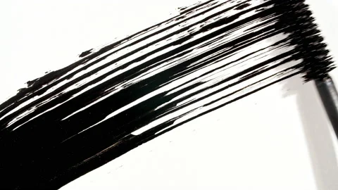 Macro shot and slow motion of a black mascara isolated on white background Stock Footage 186743829