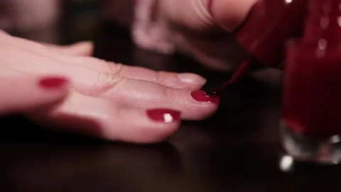 Macro shot of applying red nail polish on fingernail Stock Footage 329116713