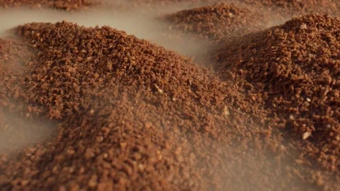 Macro shot of aromatic coffee of medium grinding is shrouded in light smoke Stock Footage 165191599