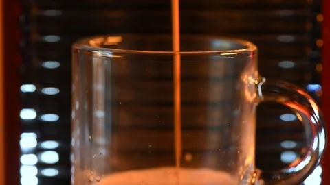 Macro shot of automatic coffee machine pouring espresso into a glass cup Stock Footage 172407386