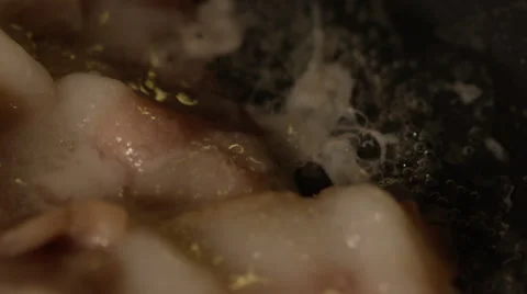 Macro shot of bacon bubbling in frying pan Stock Footage 58889431