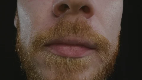 Macro shot of bearded man taking pill isolated. Stock Footage 123201290