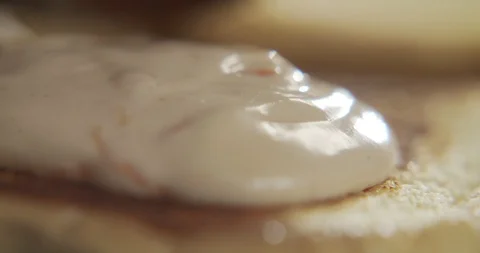 Macro shot of beef patty put on bun with sauce. Cooking burger Stock Footage 117334054