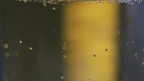 Macro shot of beer bubbles splashing as it is poured Stock Footage 86081535
