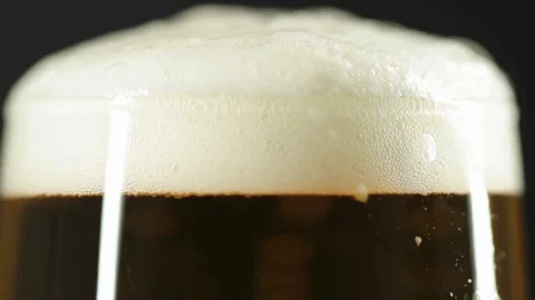 Macro shot of beer Slow Motion Macro video of beer being poured into a glass Stock Footage 265767144