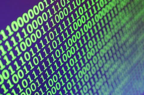 Macro shot of binary code on the monitor of an office computer. The concept o Stock Photos