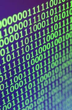 Macro shot of binary code on the monitor of an office computer. The concept o 写真素材