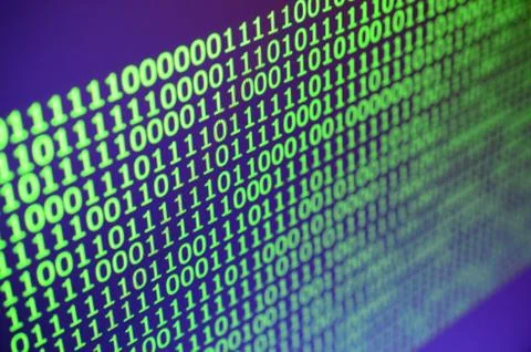Macro shot of binary code on the monitor of an office computer. The concept o Stock Photos