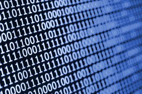 Macro shot of binary code on the monitor of an office computer. The concept o Stock Photos