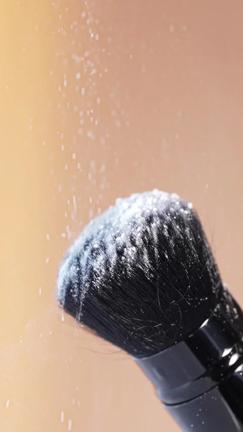 A macro shot of a black makeup brush as rice powder falls slowly over it, s.. Stock Footage 312466754