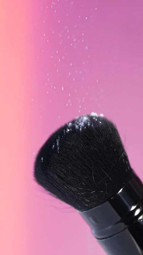 A macro shot of a black makeup brush with rice powder falling slowly onto i.. Stock Footage 312466817