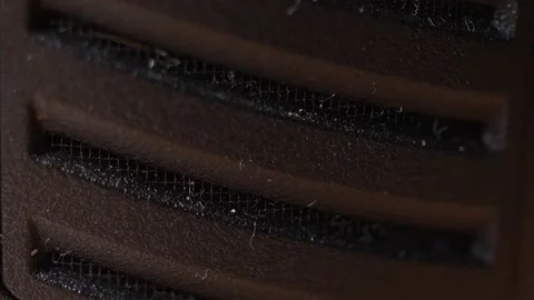 Macro shot of black plastic ventilation grille with dusty mesh. Stock Footage 322112334