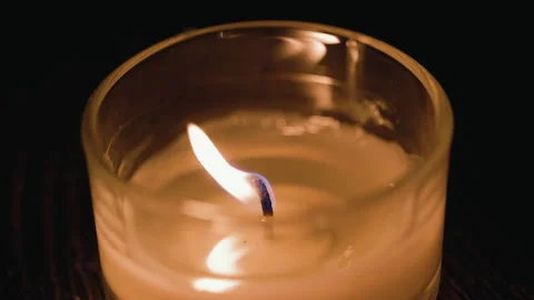 Macro shot of blow out Single candle in glass indoor at home in dusk. Stock Footage 235564091