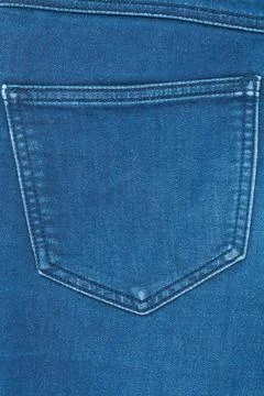 Macro shot of blue denim back pocket. Detailed view of fabric texture and sea 库存照片
