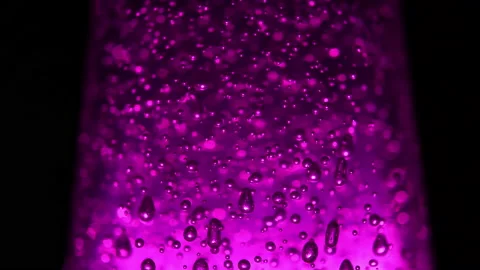 Macro shot of blurred bubbles on illuminating violet background Stock Footage 153498306