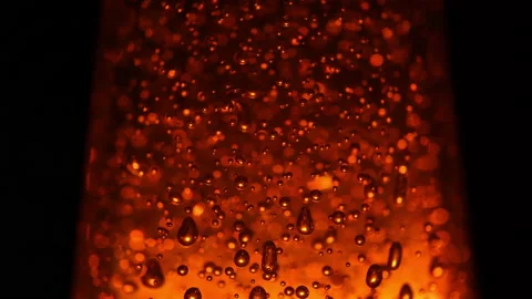Macro shot of blurred bubbles on illuminating dark golden background Stock-Footage 154463120