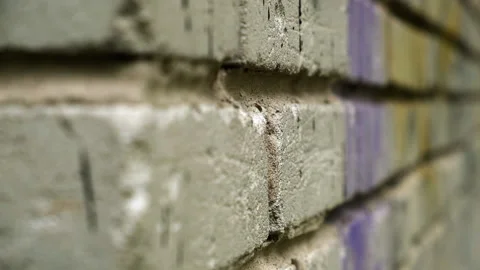 Macro shot of Brick Wall. Old Porous Brick. Graffiti. Ghetto. Urban Environment Stock Footage 145043207