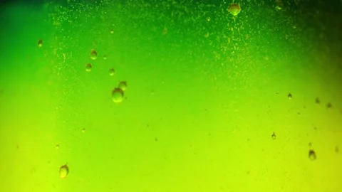 Macro shot of a bright green fluid with fine particles and air bubbles Stock Footage 340636749