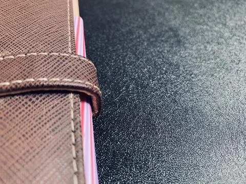 Macro Shot of Brown Leather Notebook Strap on Dark Desk in Jakarta Indonesia Stock Photos
