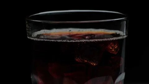 Macro shot of bubbles and ice in Cola Stock Footage 141809585