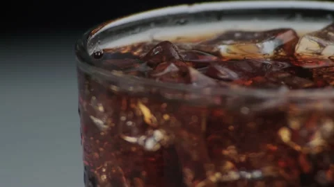Macro shot of bubbles and ice in Cola Stock Footage 141817550