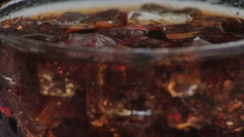 Macro shot of bubbles and ice in Cola Stock Footage 141818344
