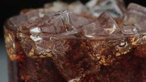 Macro shot of bubbles and ice in Cola Stock Footage 141819480
