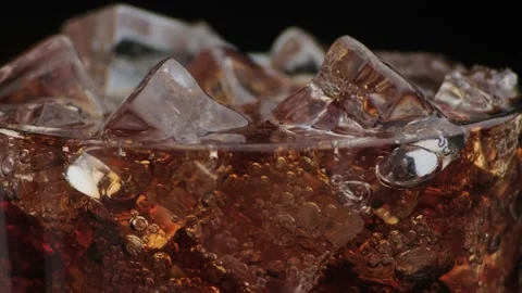Macro shot of bubbles and ice in Cola Stock Footage 141819802