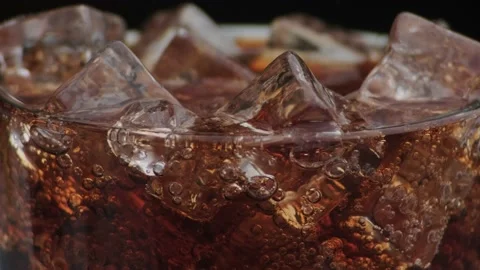 Macro shot of bubbles and ice in Cola Stock Footage 141819943