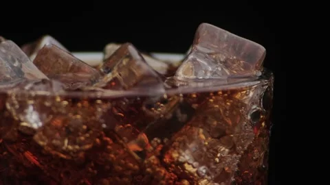 Macro shot of bubbles and ice in Cola Stock Footage 141820660