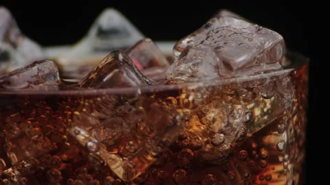 Macro shot of bubbles and ice in Cola Stock Footage 141821341
