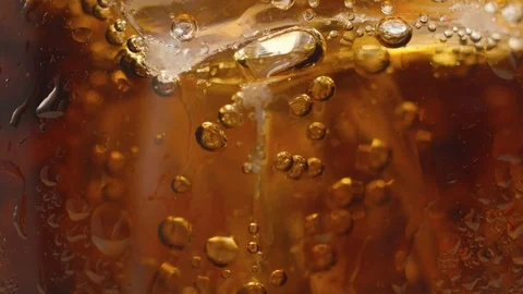 Macro shot of bubbles in glass with cola. Video in slow motion. Stock Footage 112146738