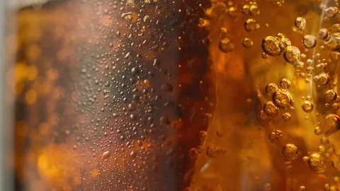 Macro shot of bubbles in glass with refreshing cola with ice Stock Footage 112146816