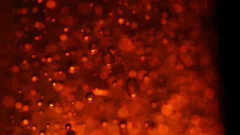 Macro shot of bubbles on illuminating dark golden background, frozen bubbles Stock Footage 148498906