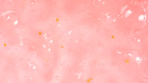 Macro shot of bubbles in peach fuzz color inside it shower gel. Close up of.. Stock Footage 275061731