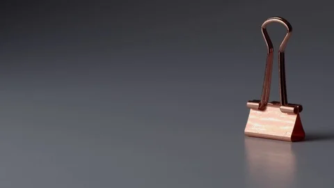 Macro shot of bulldog clips falling into frame Stock Footage 117350366