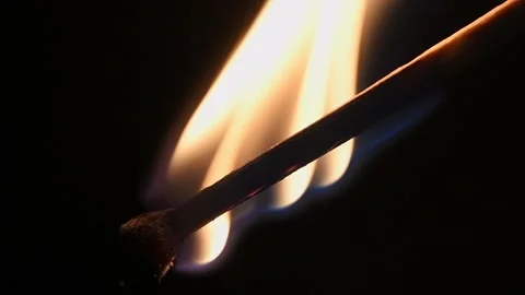 Macro shot of a burning matchstick on a black background. Stock Footage 325910647