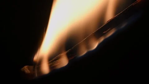 Macro shot of a burning matchstick on a black background. Stock Footage 325910653